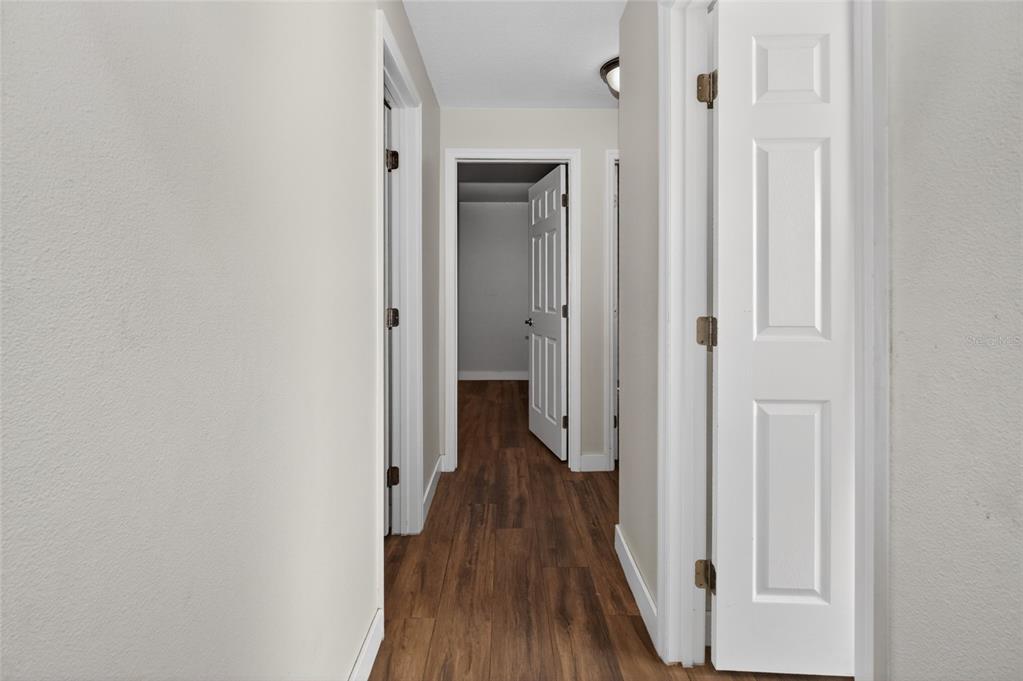 7023 Talbot Drive Orlando, FL 32819 - Photo 19 of 34 a view of a hallway with wooden floor