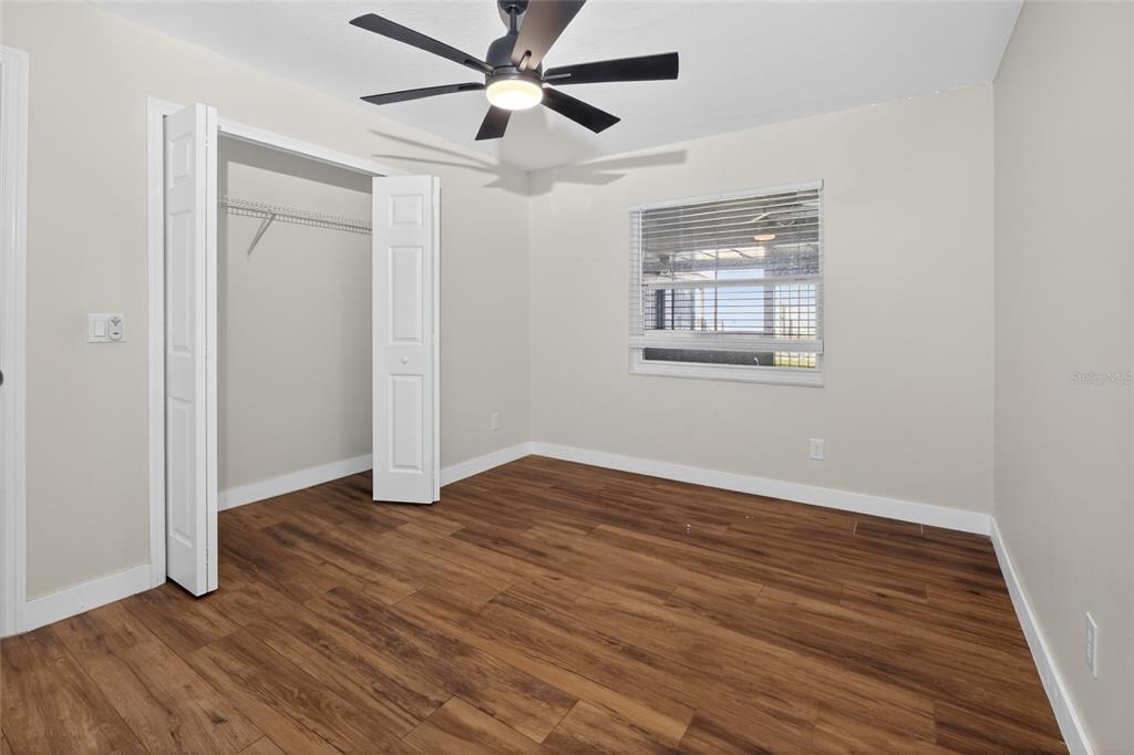 7023 Talbot Drive Orlando, FL 32819 - Photo 20 of 34 a view of an empty room with wooden floor and a window