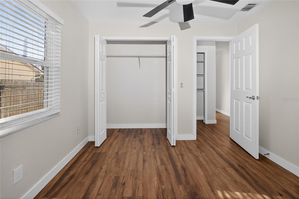 7023 Talbot Drive Orlando, FL 32819 - Photo 24 of 34 an empty room with wooden floor and windows