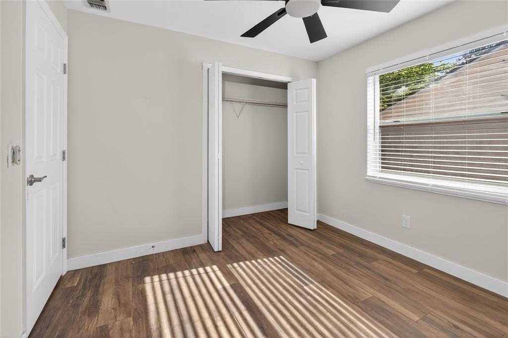 7023 Talbot Drive Orlando, FL 32819 - Photo 25 of 34 wooden floor in an empty room with a window