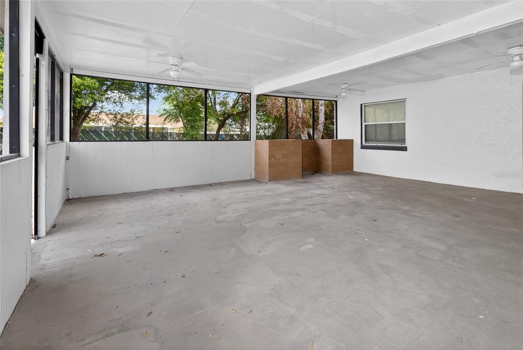 7023 Talbot Drive Orlando, FL 32819 - Photo 27 of 34 a view of an empty room with a window and a kitchen
