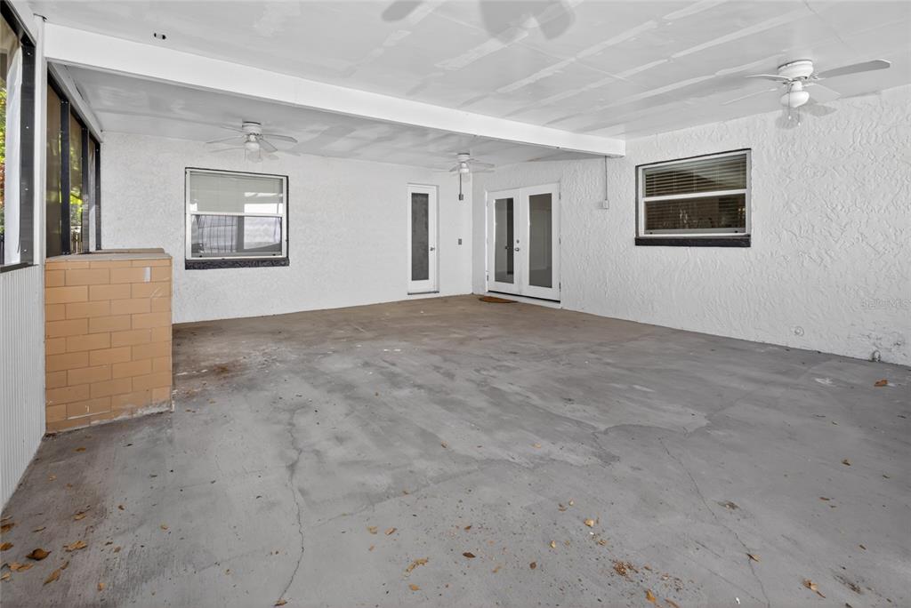 7023 Talbot Drive Orlando, FL 32819 - Photo 28 of 34 an empty room with windows and cabinet