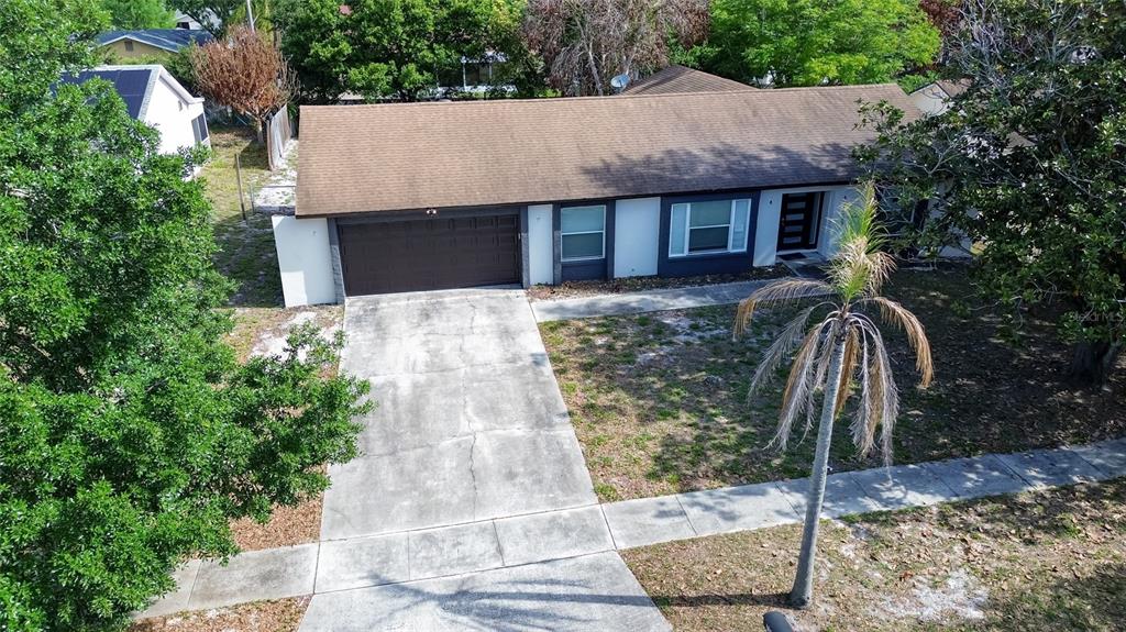 7023 Talbot Drive Orlando, FL 32819 - Photo 3 of 34 a front view of a house with garden
