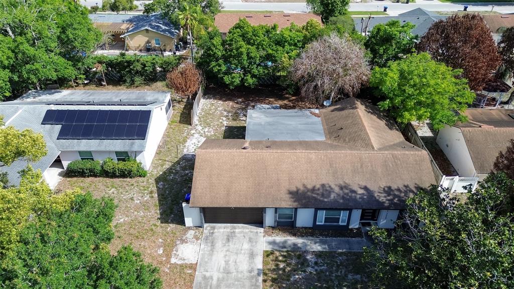 7023 Talbot Drive Orlando, FL 32819 - Photo 4 of 34 an aerial view of a house with a yard and potted plants