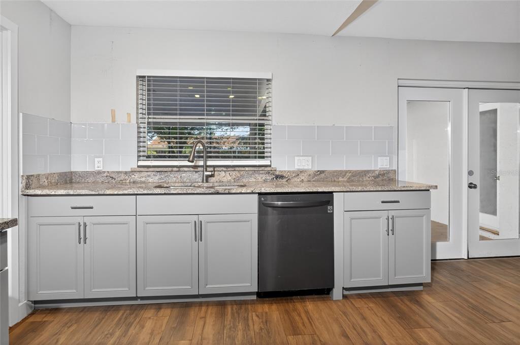 7023 Talbot Drive Orlando, FL 32819 - Photo 9 of 34 a kitchen with granite countertop cabinets stainless steel appliances and a sink