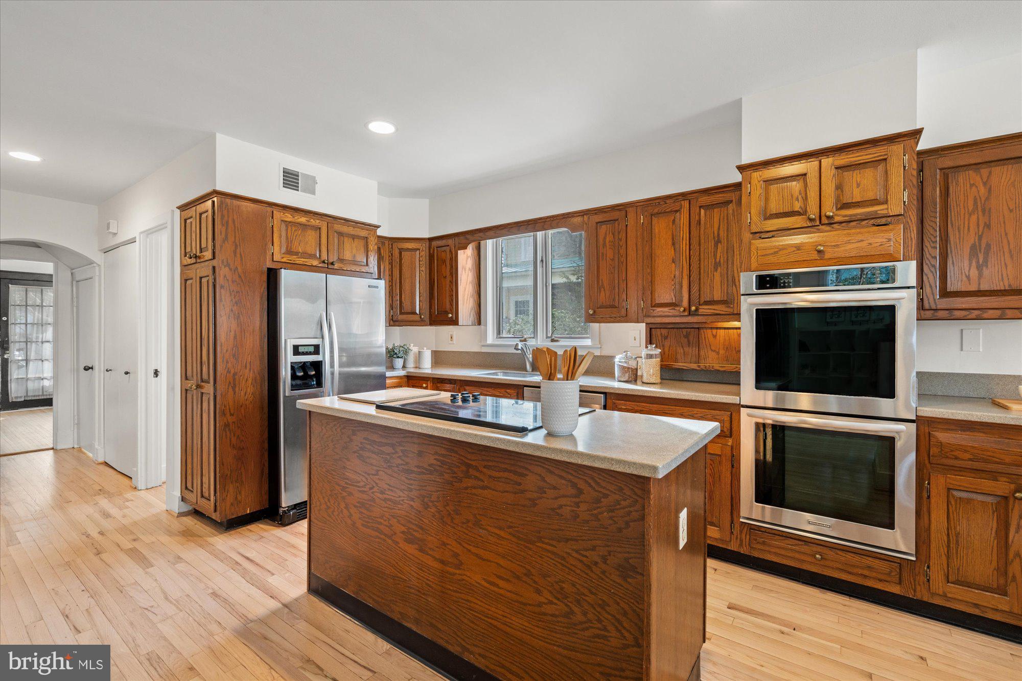 3803 Taylor Street Chevy Chase, MD 20815 - Photo 12 of 35 a kitchen with stainless steel appliances granite countertop a refrigerator stove top oven and sink