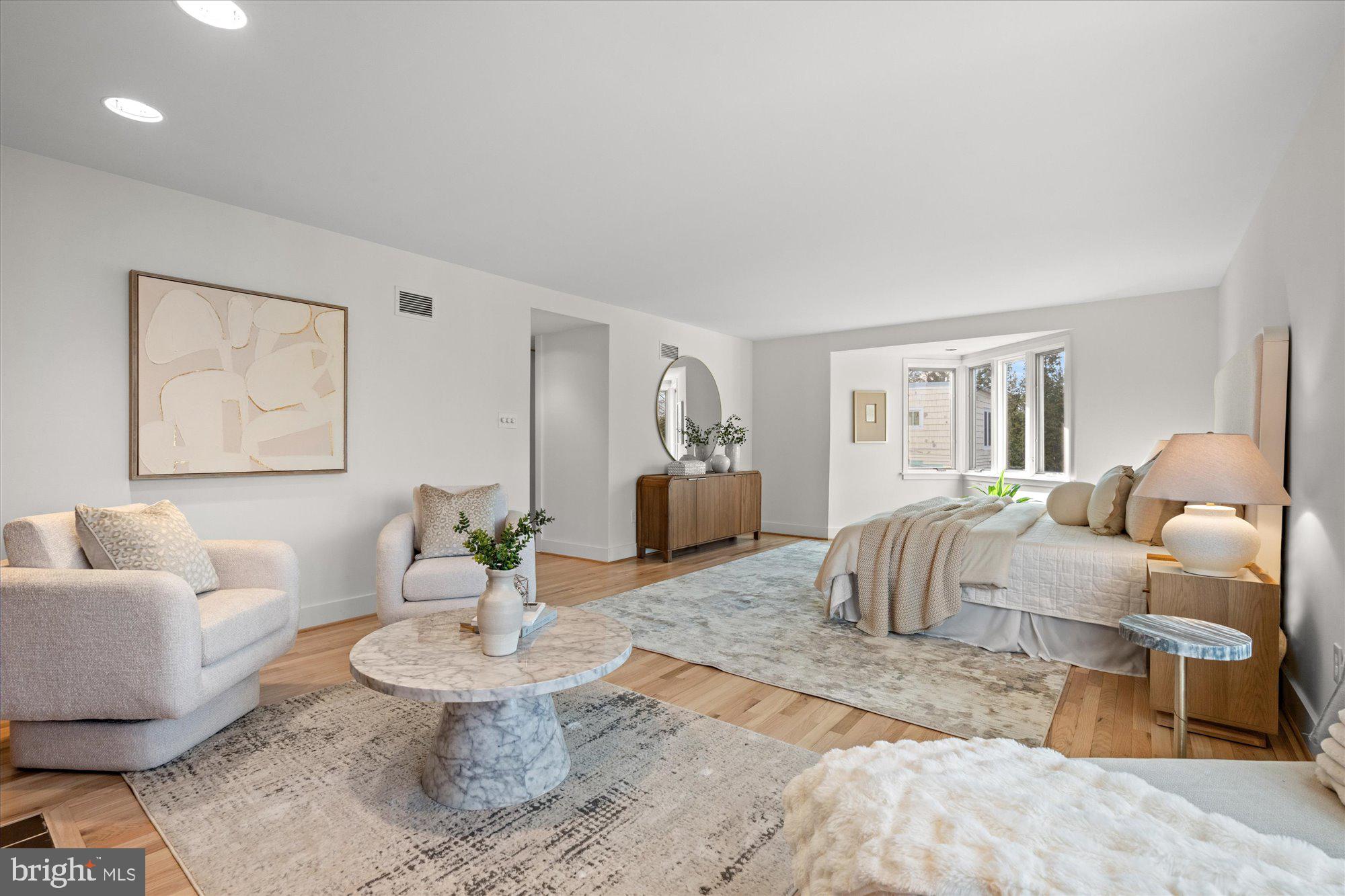 3803 Taylor Street Chevy Chase, MD 20815 - Photo 18 of 35 a spacious bedroom with a bed a couch and a potted plant