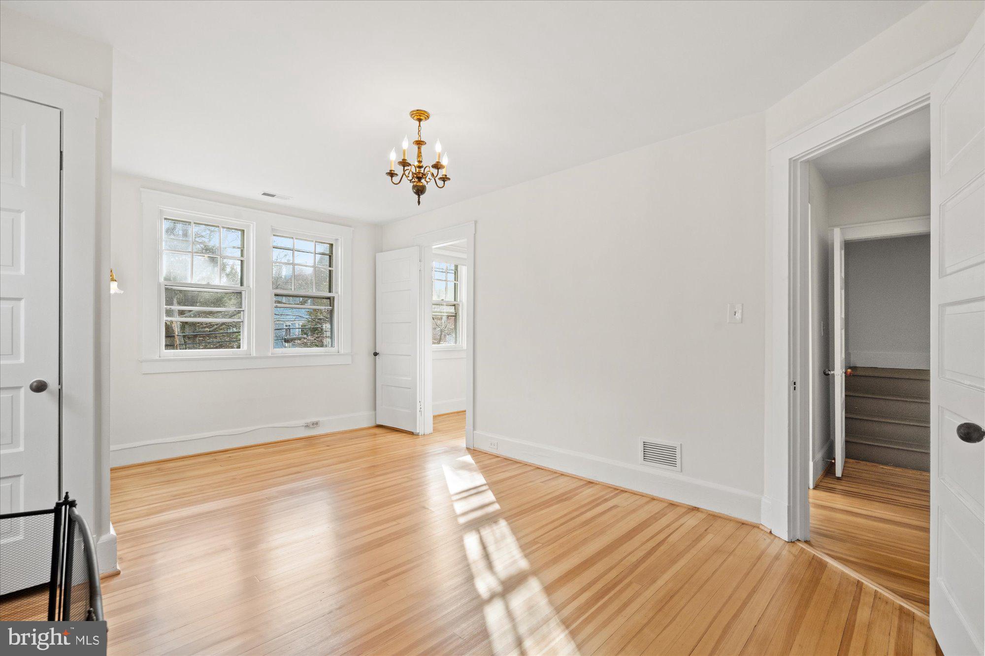 3803 Taylor Street Chevy Chase, MD 20815 - Photo 23 of 35 a view of an empty room with wooden floor and a window