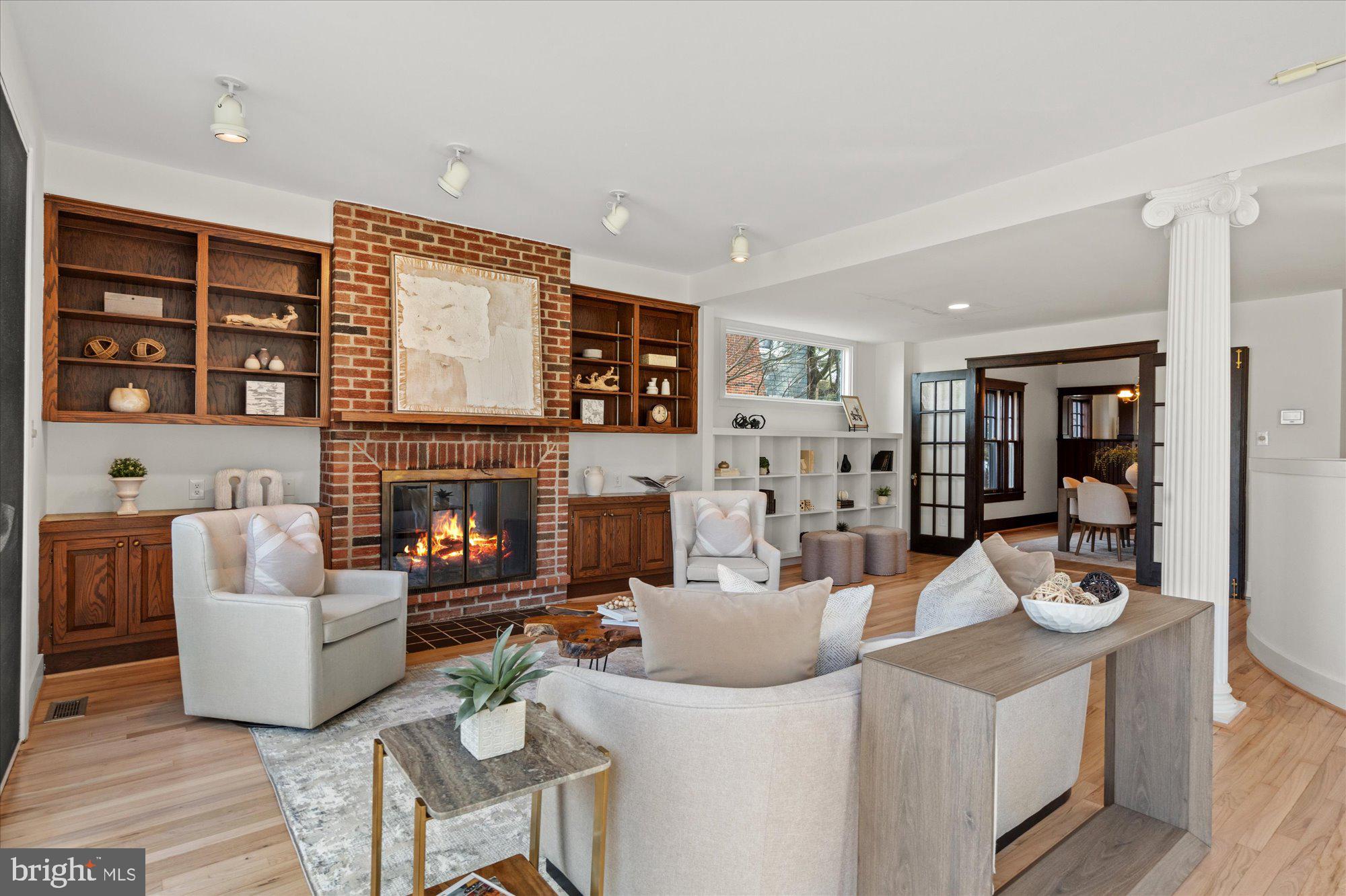 3803 Taylor Street Chevy Chase, MD 20815 - Photo 8 of 35 a living room with furniture a fireplace and a large window