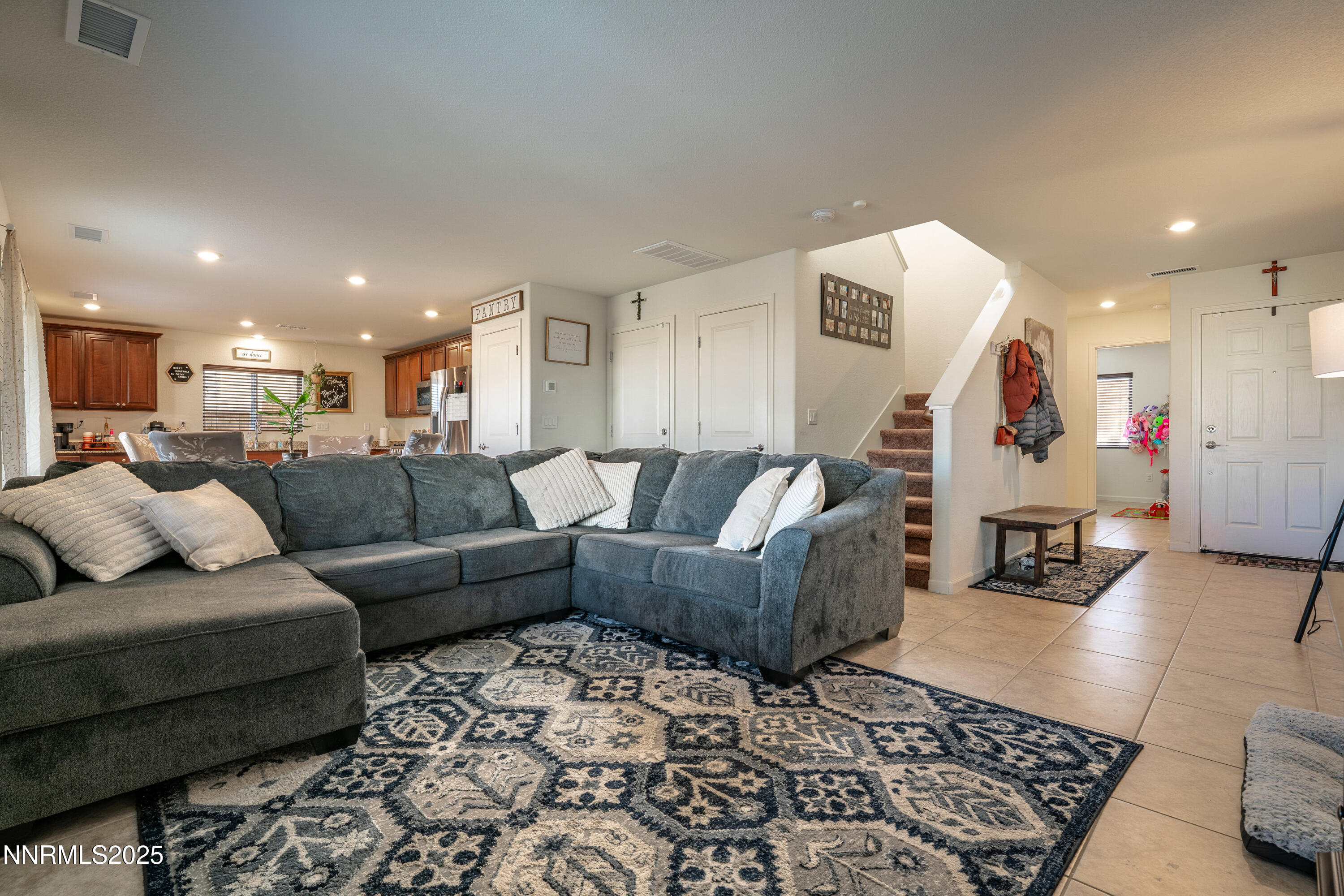 a living room with furniture and kitchen view