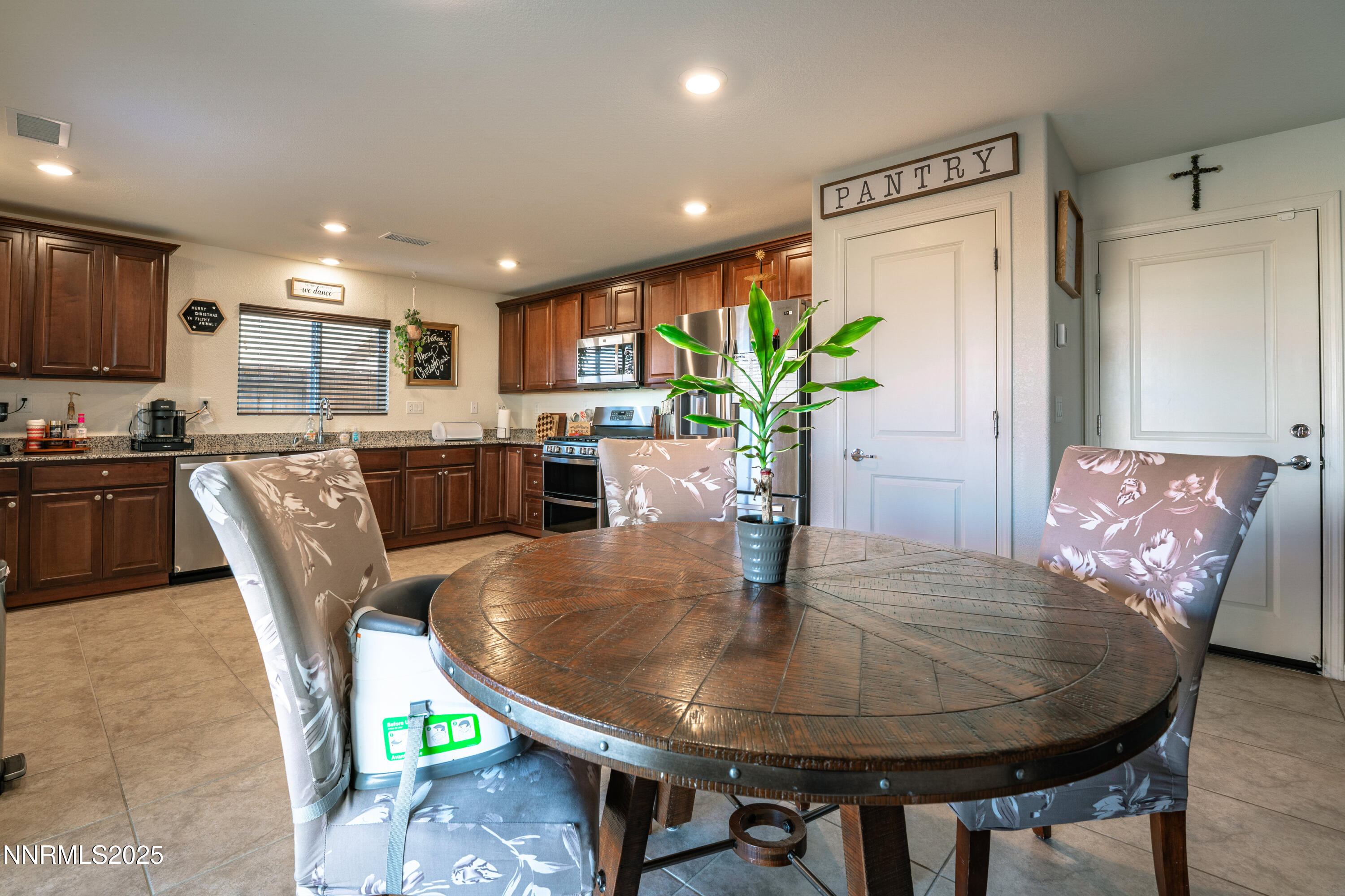 909 Convair Way Reno, NV 89506 - Photo 13 of 42 a dining room with furniture and a kitchen view