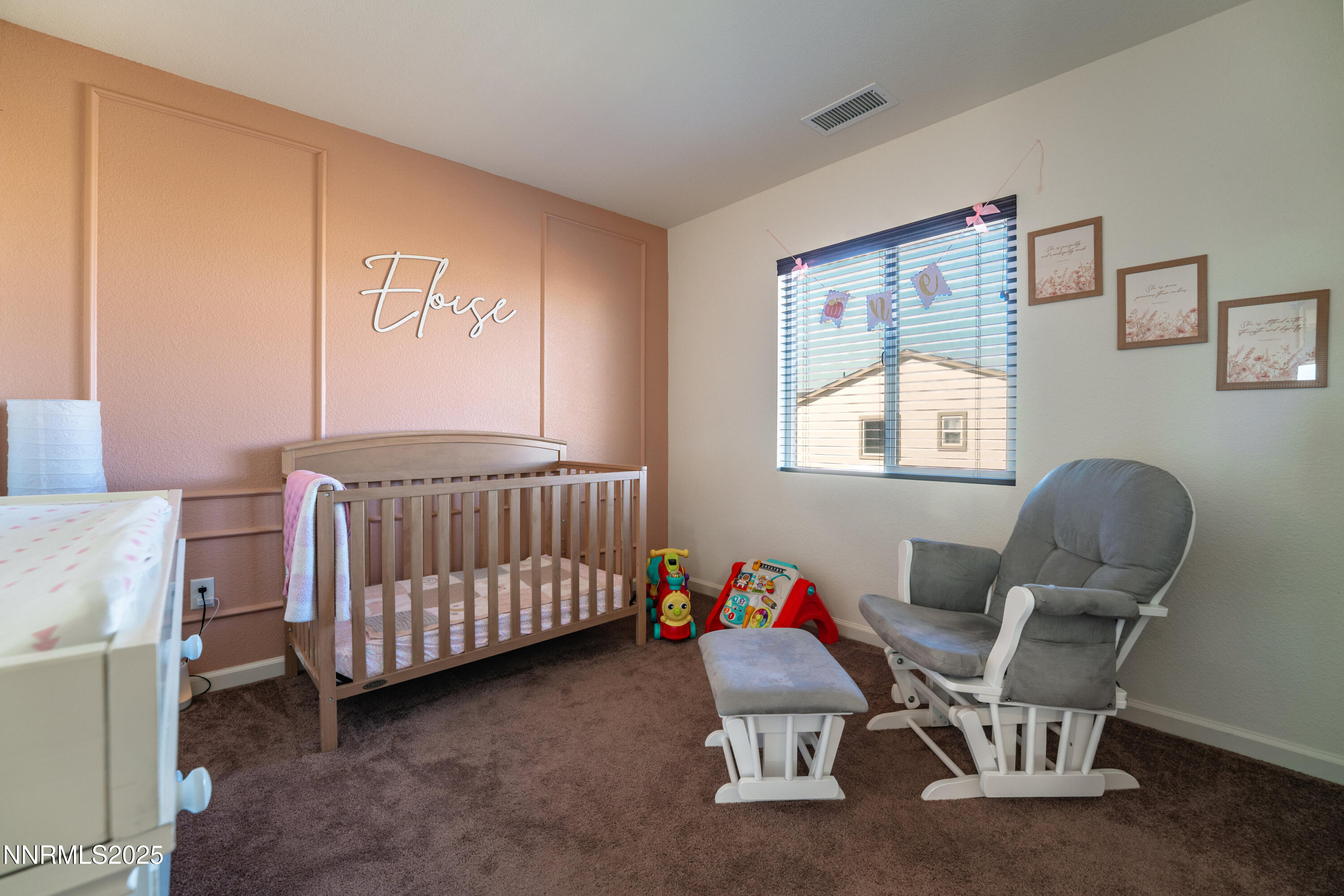 909 Convair Way Reno, NV 89506 - Photo 25 of 42 a bedroom with a baby bed chair and a window