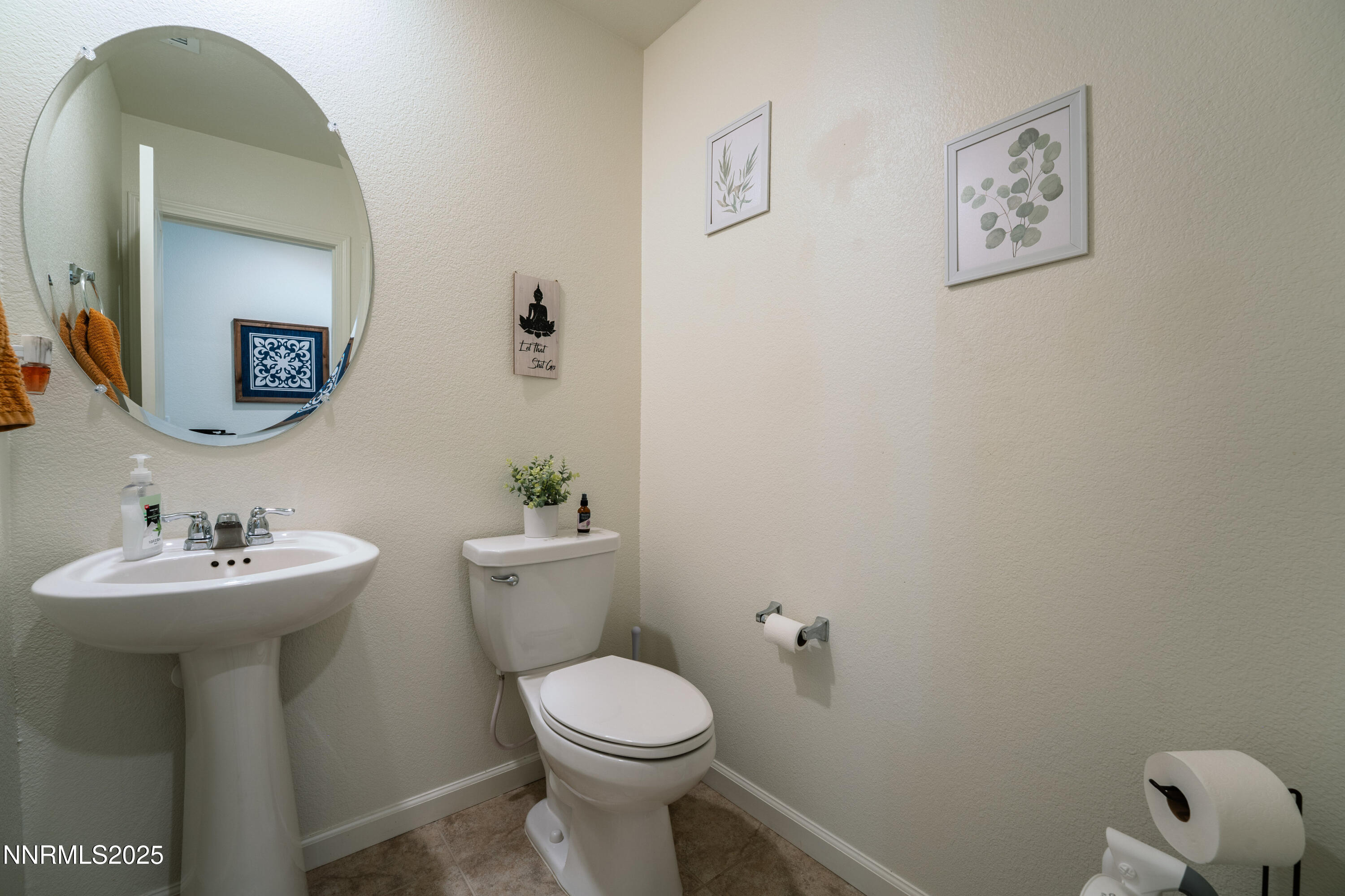 909 Convair Way Reno, NV 89506 - Photo 31 of 42 a bathroom with a toilet sink and mirror