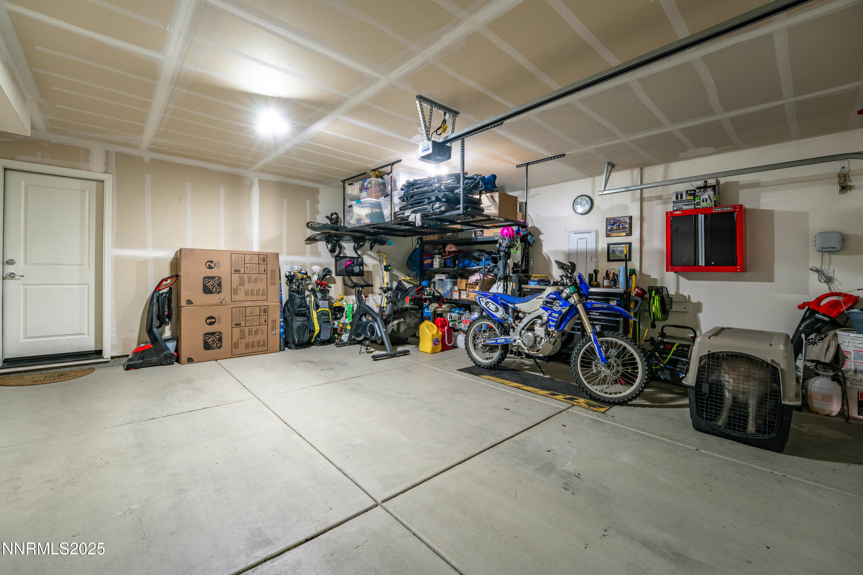 909 Convair Way Reno, NV 89506 - Photo 37 of 42 a view of a garage with a bike and car