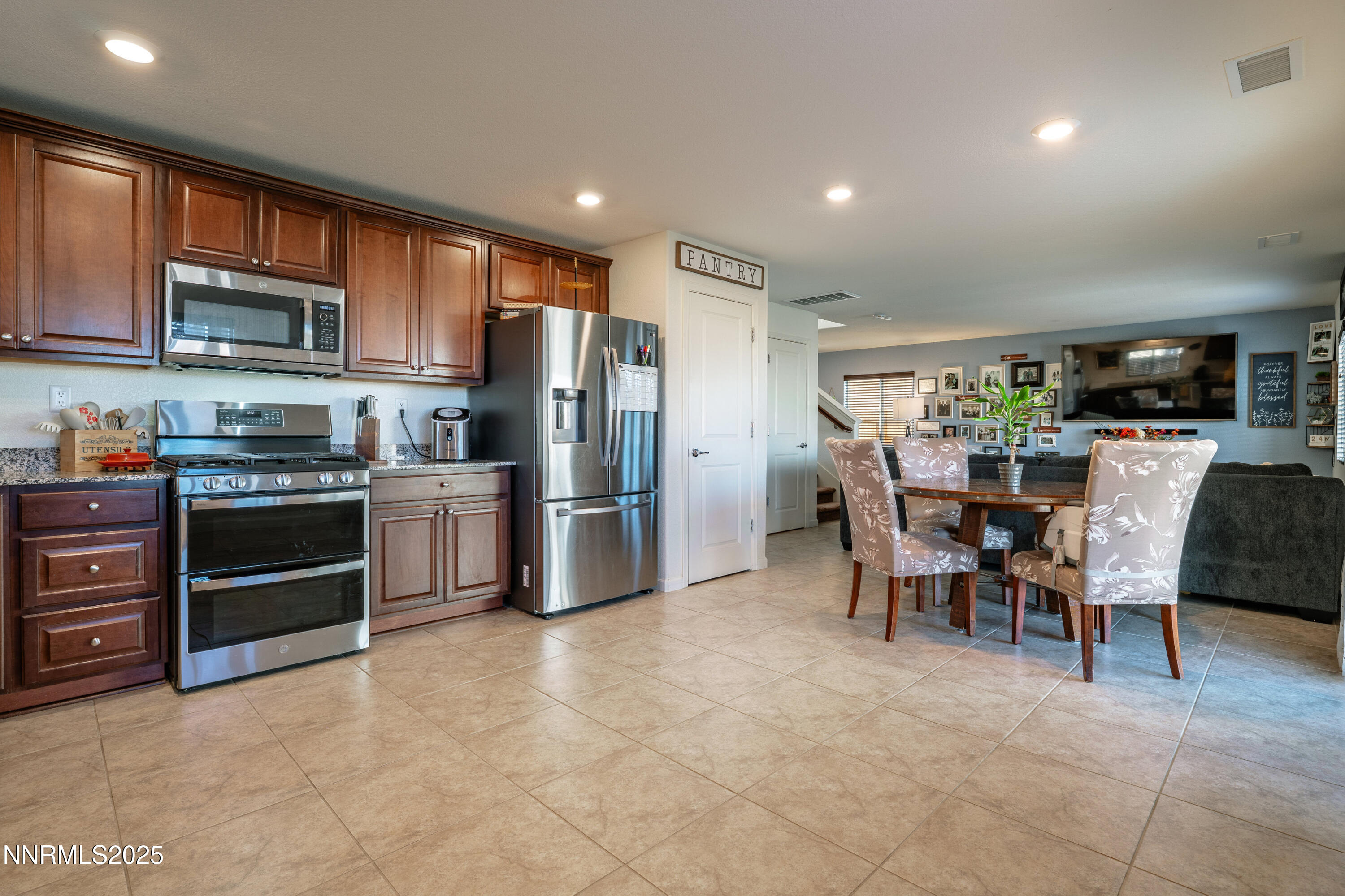 909 Convair Way Reno, NV 89506 - Photo 10 of 42 a kitchen with stainless steel appliances kitchen island granite countertop a refrigerator and cabinets