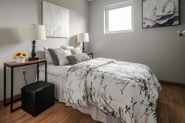 a bedroom with bed and window