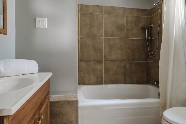 a bathroom with a bathtub and toilet