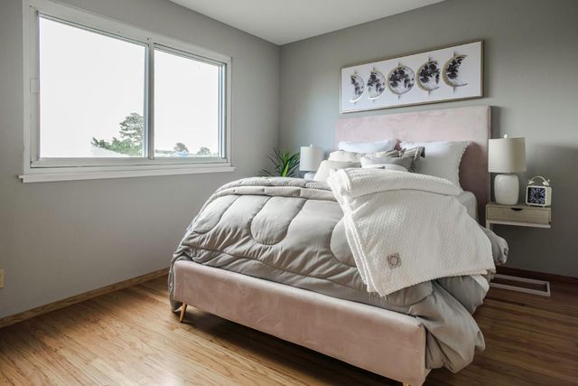 a bed sitting in a bedroom next to a window