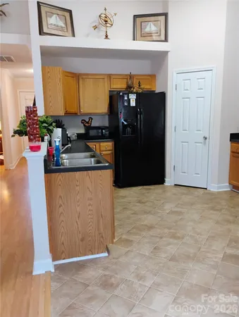 a kitchen with stainless steel appliances granite countertop a refrigerator and a stove