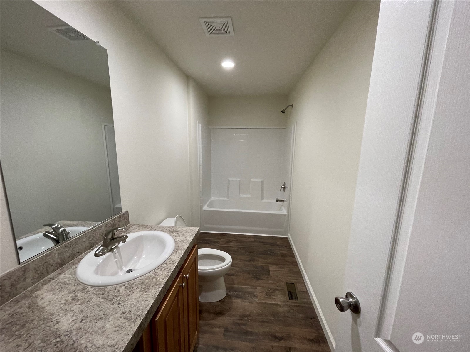 2610 Calawah Way, Unit 5 Forks, WA 98331 - Photo 8 of 12 a bathroom with a granite countertop sink a mirror and a toilet