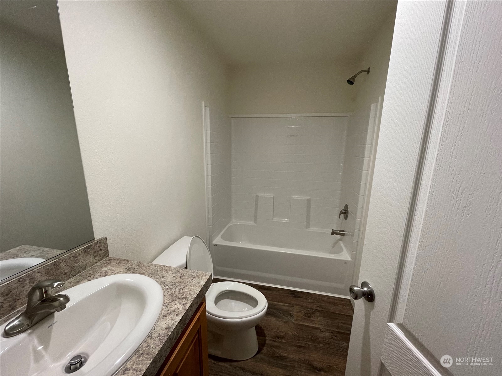 2610 Calawah Way, Unit 5 Forks, WA 98331 - Photo 9 of 12 a bathroom with a granite countertop sink and a bathtub