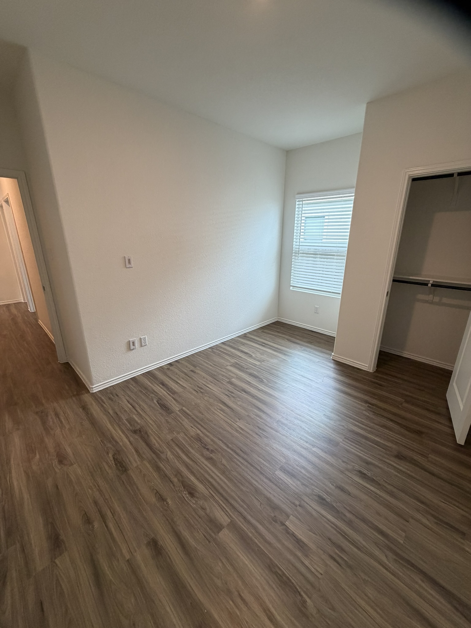 408 Buckners Street Georgetown, TX 78626 - Photo 8 of 15 an empty room with wooden floor and entrance