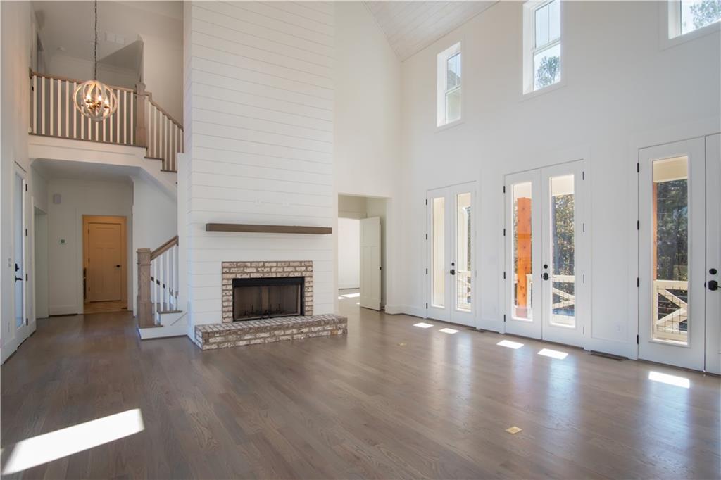 Lot 1 Cox Road Roswell, GA 30075 - Photo 21 of 36 a view of a livingroom with a fireplace wooden floor and windows