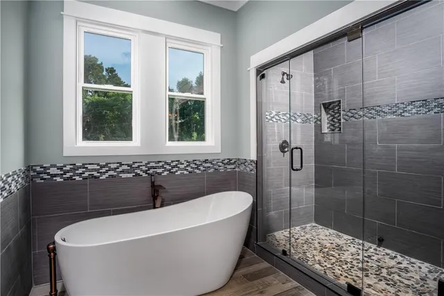 a view of empty room with wooden floor and fireplace
