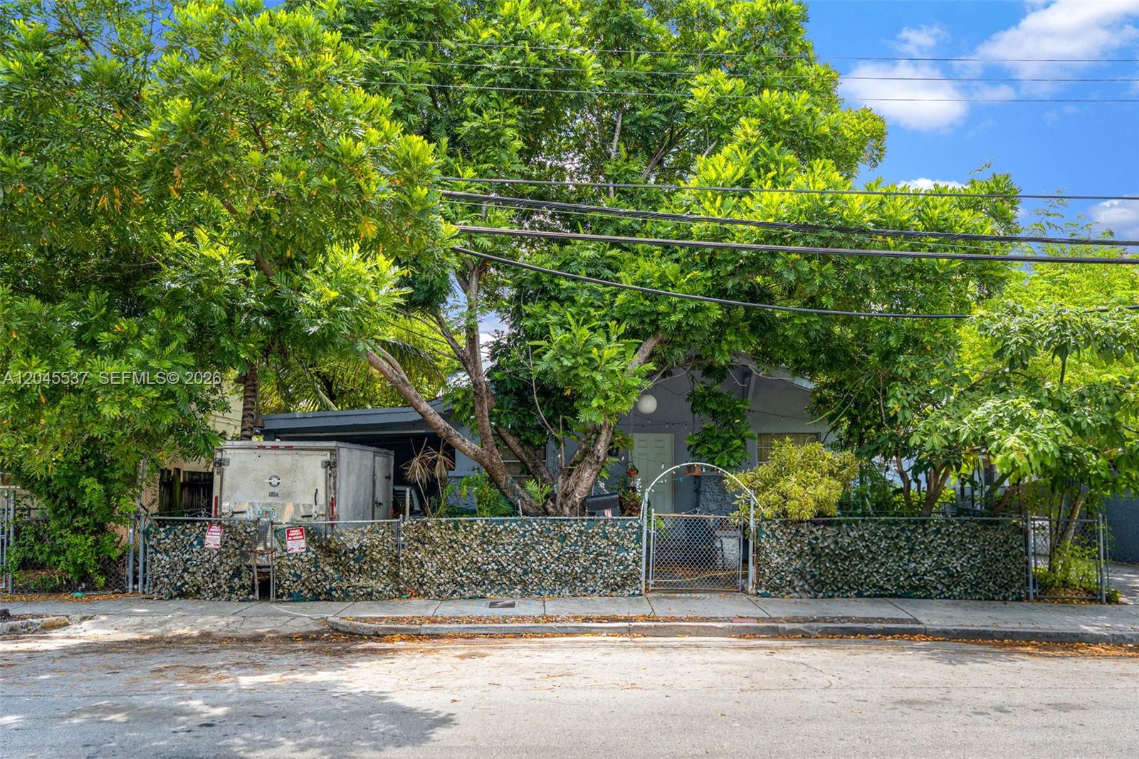 210 Southwest 13th Avenue Miami, FL 33135 - Photo 1 of 13 a front view of a house with a garden and trees
