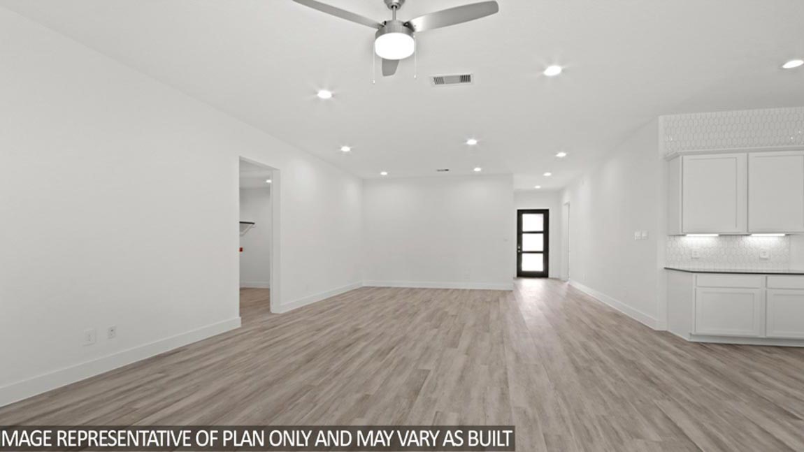 15219 Riverside Drive Baytown, TX 77523 - Photo 3 of 14 a view of an empty room with a window and wooden floor