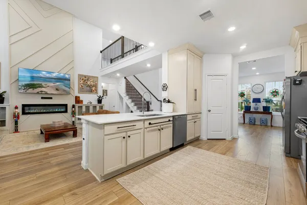 a open kitchen with sink cabinets and wooden floor