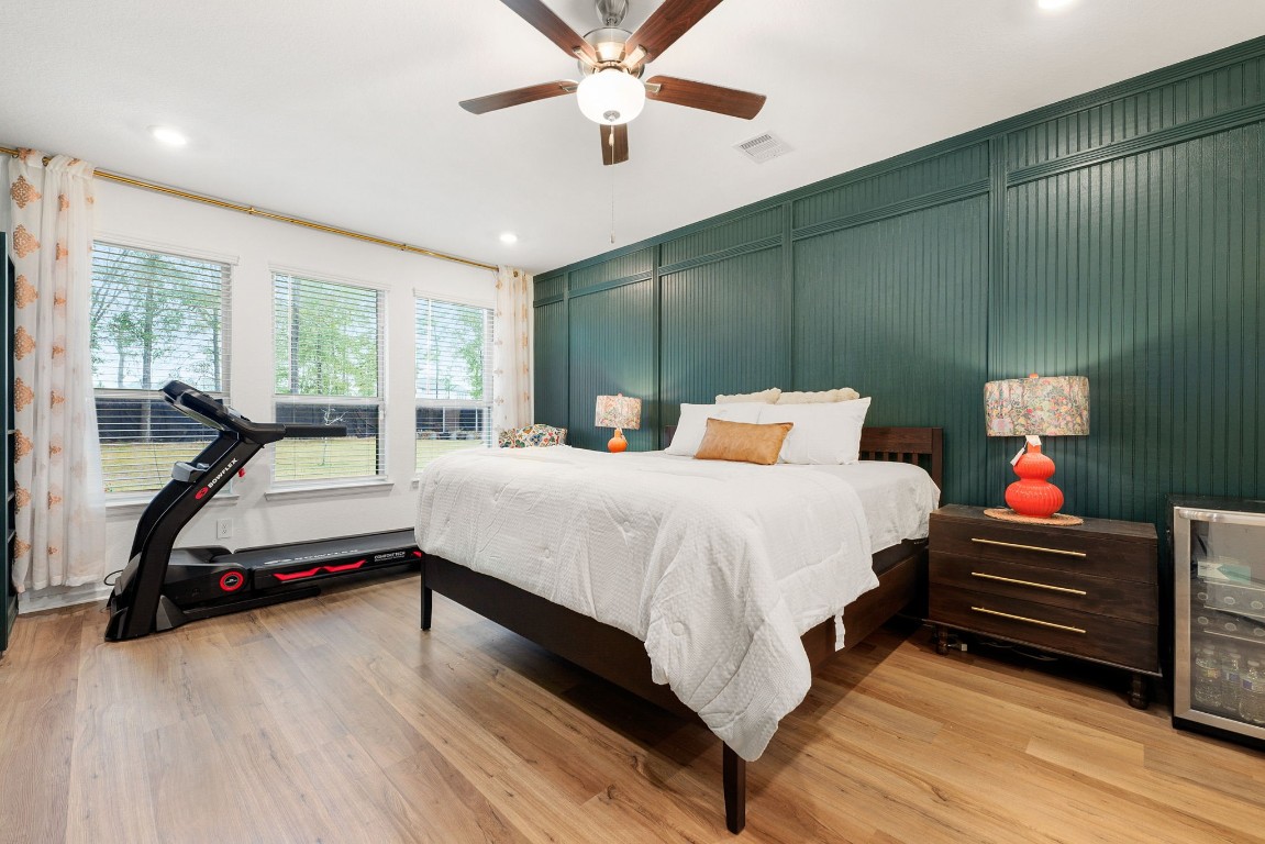 15500 Leopard Lily Lane Conroe, TX 77302 - Photo 18 of 50 a bedroom with a bed and a chandelier