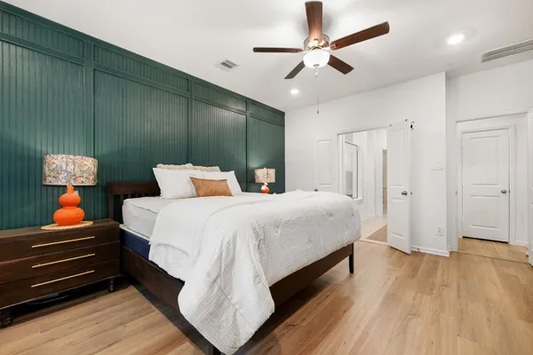 a bedroom with a bed and a chandelier