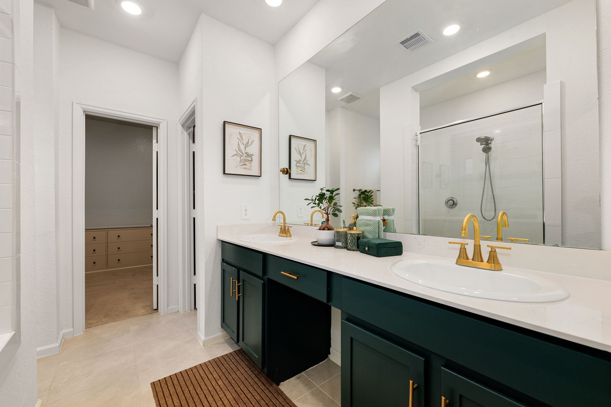 15500 Leopard Lily Lane Conroe, TX 77302 - Photo 20 of 46 a bathroom with a sink double vanity and a mirror