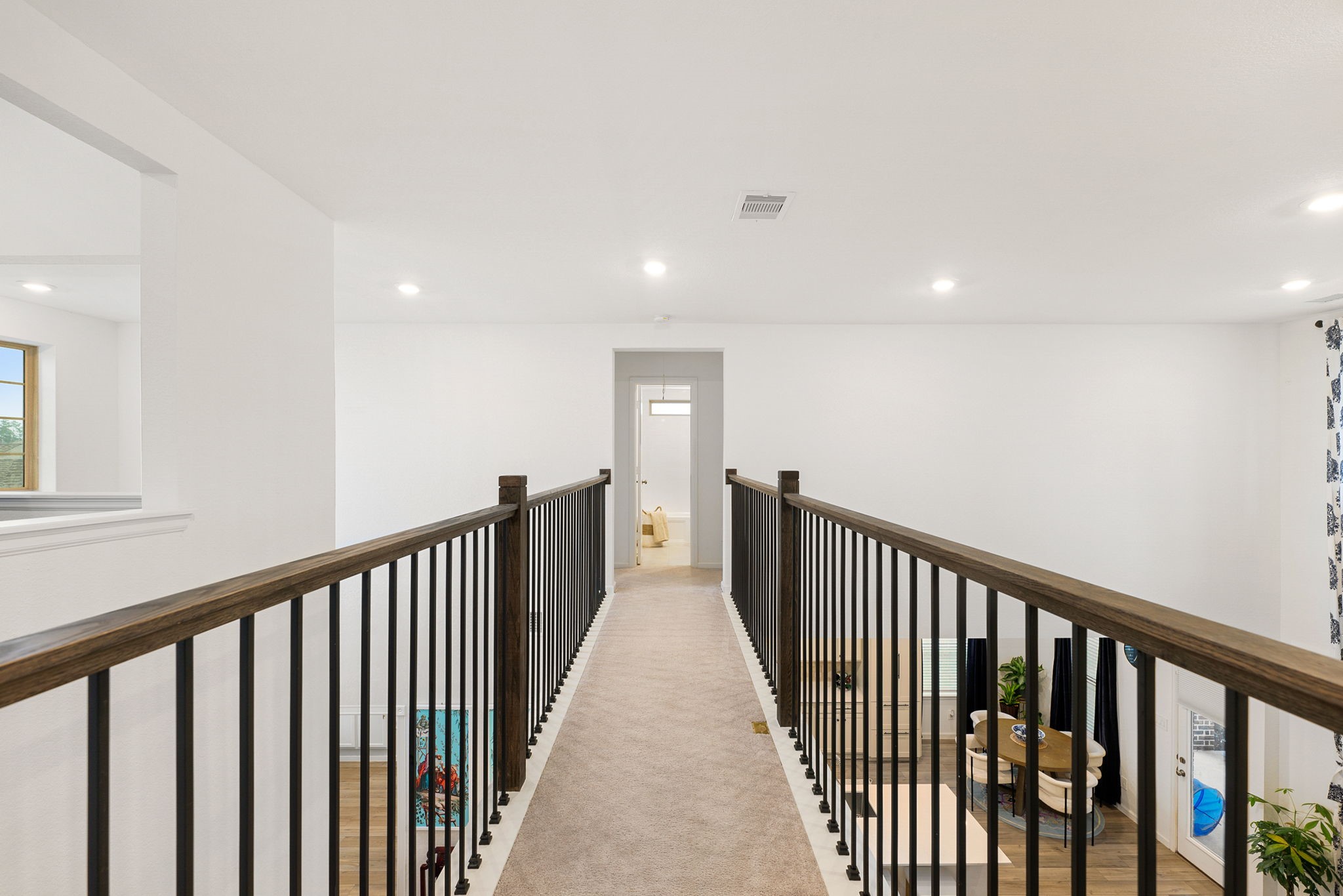 15500 Leopard Lily Lane Conroe, TX 77302 - Photo 22 of 46 a view of a hallway with wooden floor