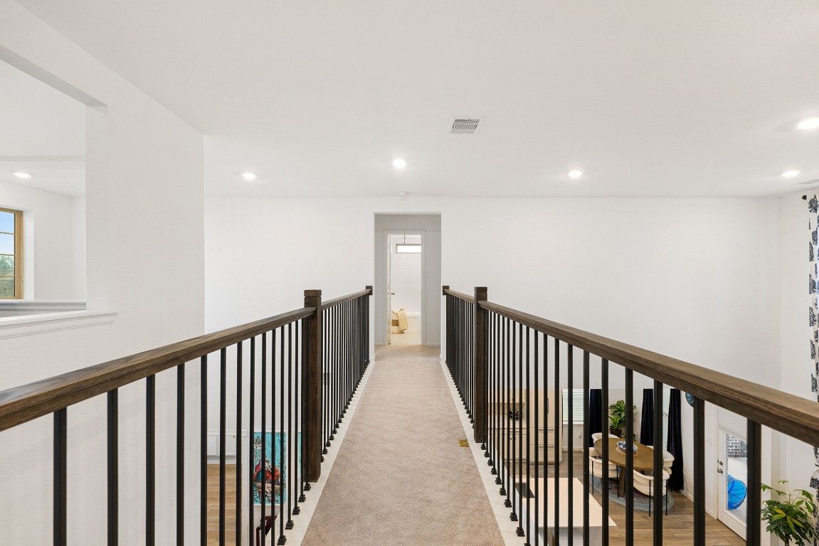 15500 Leopard Lily Lane Conroe, TX 77302 - Photo 22 of 50 a view of a hallway with wooden floor
