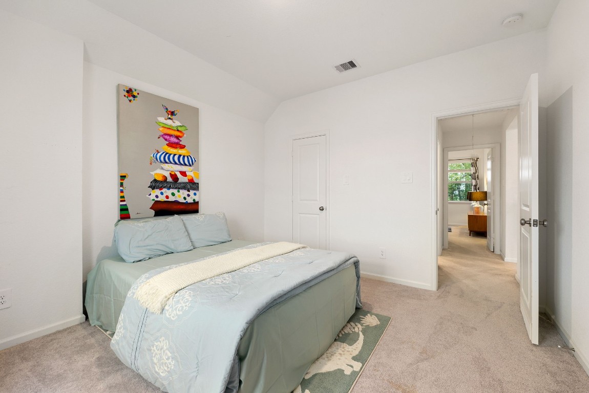 15500 Leopard Lily Lane Conroe, TX 77302 - Photo 29 of 50 a bedroom with a bed and a cabinets