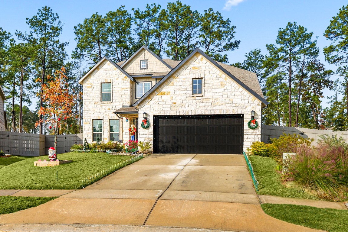 15500 Leopard Lily Lane Conroe, TX 77302 - Photo 3 of 50 a front view of a house with yard