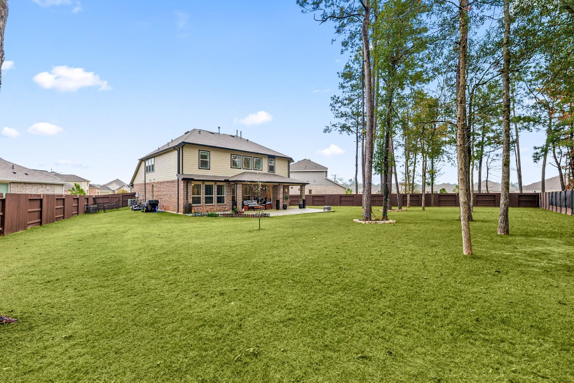 15500 Leopard Lily Lane Conroe, TX 77302 - Photo 38 of 50 a view of a house with a big yard