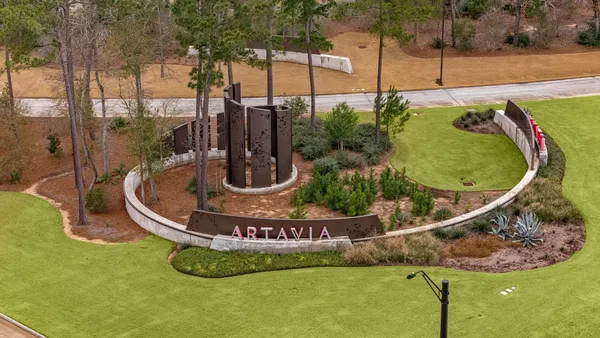 an aerial view of residential houses with outdoor space