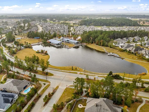 an aerial view of a house with a yard and lake view
