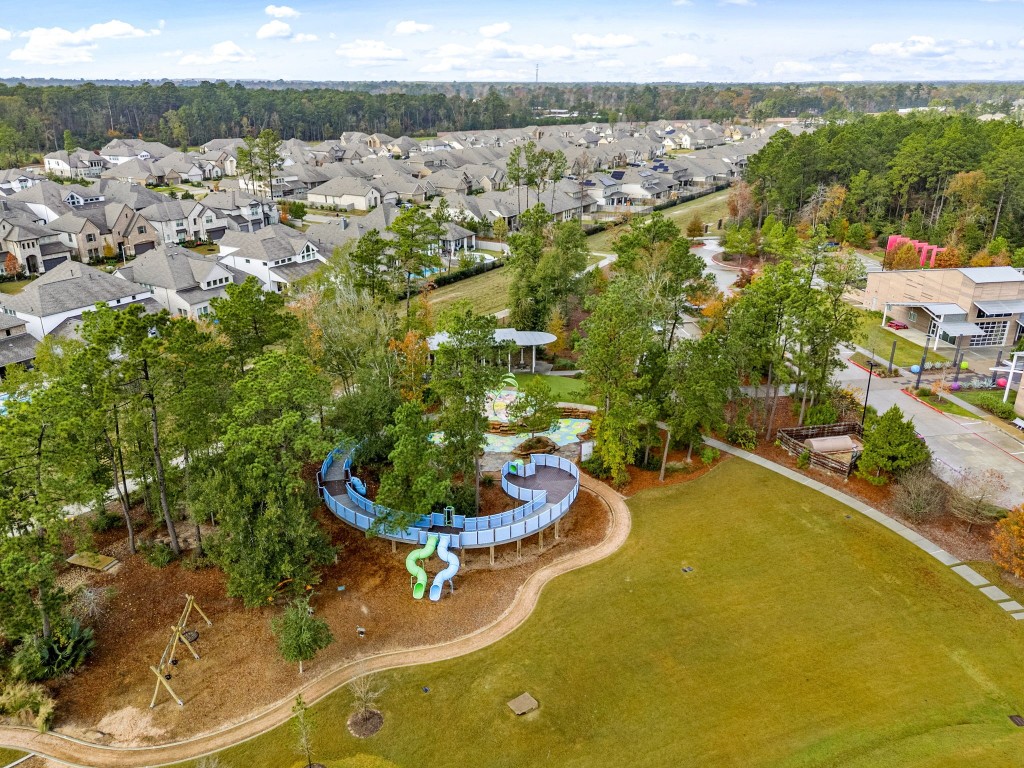 15500 Leopard Lily Lane Conroe, TX 77302 - Photo 50 of 50 an aerial view of a house with a yard and lake view