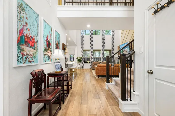 a dining room with wooden floor and furniture