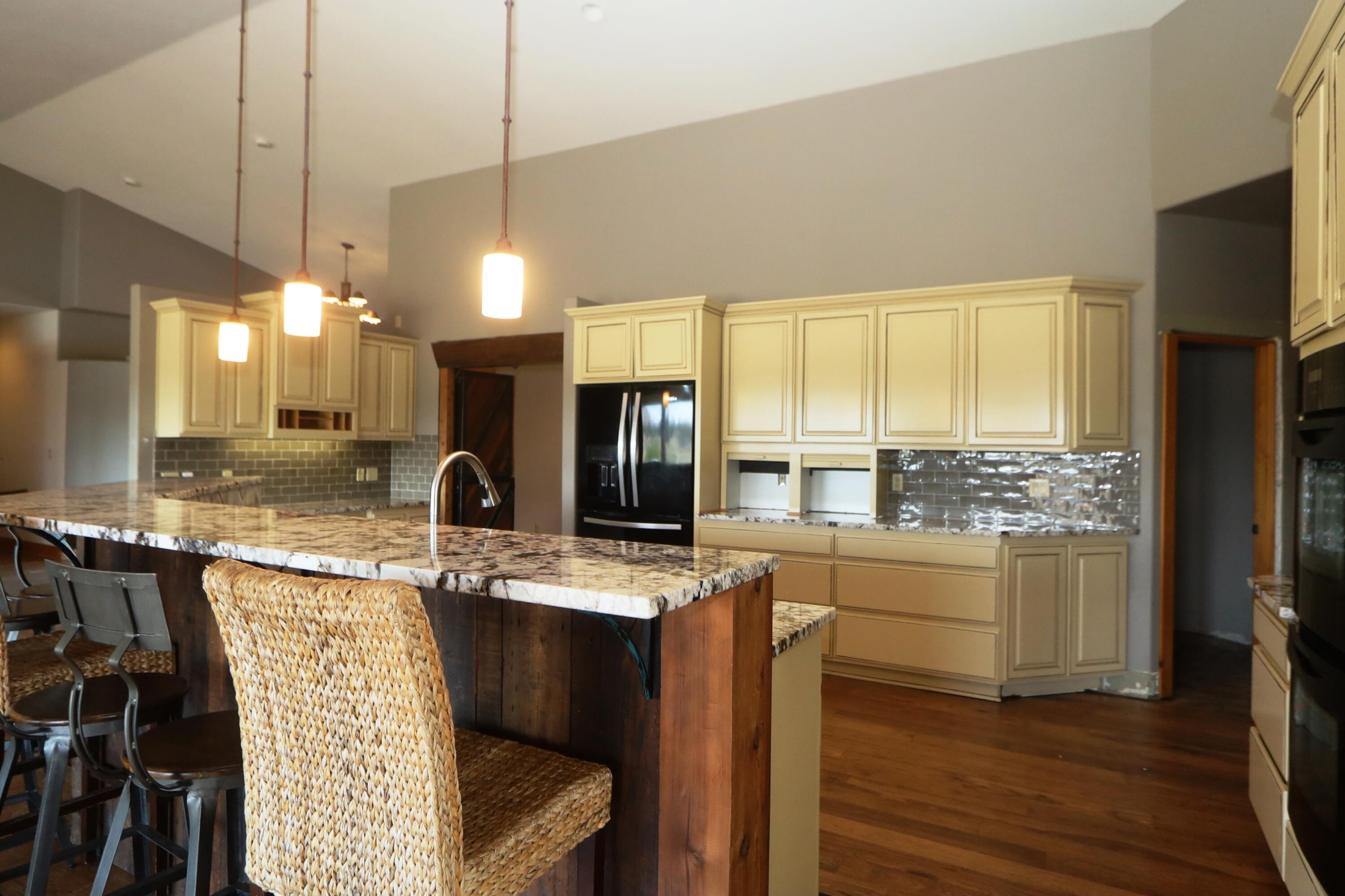 21491 Bear Creek Road Bend, OR 97701 - Photo 11 of 45 a kitchen with stainless steel appliances granite countertop sink stove and refrigerator