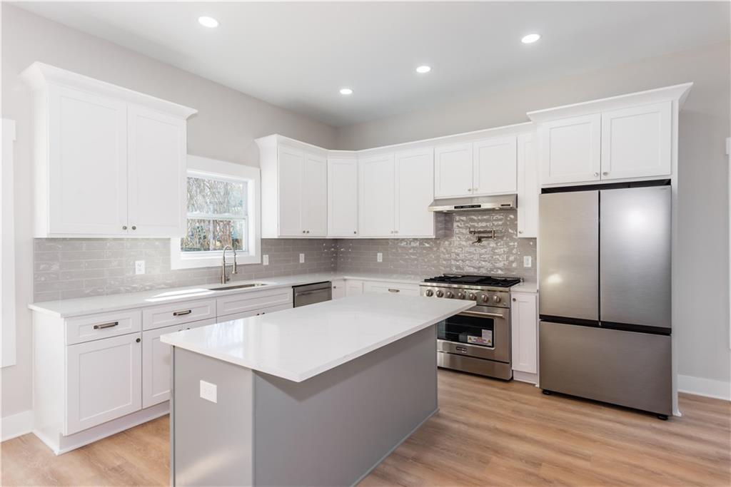 3286 Bachelor Street East Point, GA 30344 - Photo 21 of 45 a kitchen with a refrigerator sink and cabinets