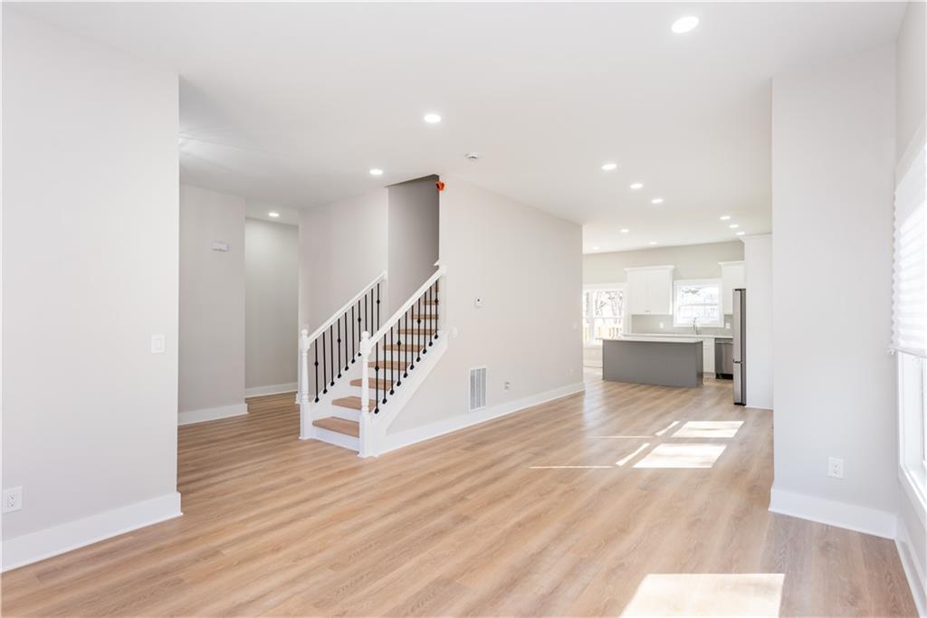 3286 Bachelor Street East Point, GA 30344 - Photo 28 of 45 a view of an empty room with wooden floor and a kitchen
