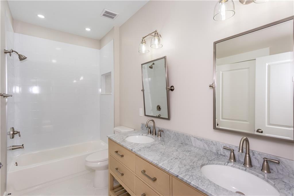 3286 Bachelor Street East Point, GA 30344 - Photo 31 of 45 a bathroom with a granite countertop double vanity sink and mirror with bathtub