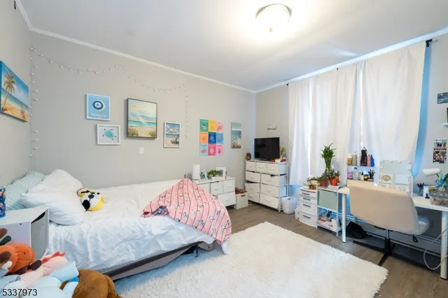 a bedroom with a bed and flat screen tv