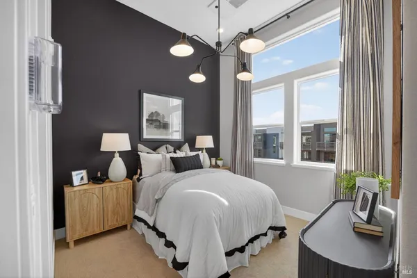 a bedroom with bed and a chandelier