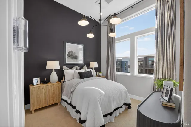 a bedroom with bed and a chandelier